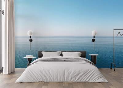 Tranquil minimalist landscape with a smooth blue sea surface with calm waters with a horizon and clear skies. Simple beautiful natural calm background. Generative AI. Wall mural