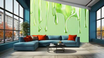 Vibrant green dripping paint against a soft pastel background indicating freshness and creativity. Wall mural