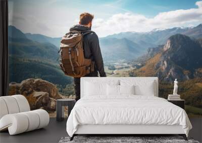 Young man with backpack hiking mountains. Hiker having trekking day out on a sunny day. Wall mural