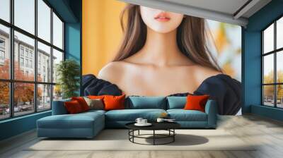 Young woman with long hair wearing a black off-shoulder dress and cat ears in a bright indoor setting. Wall mural