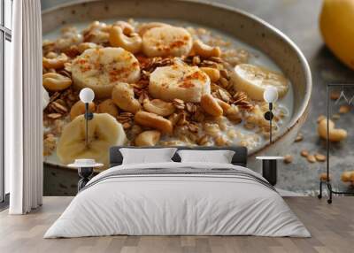 a breakfast bowl featuring rye flakes cooked in milk, topped with cashew nuts, banana, and pear Wall mural