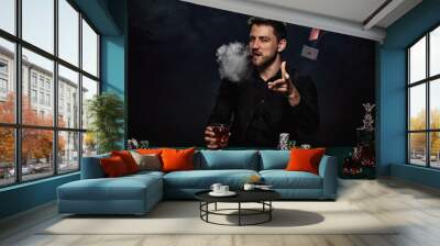 Bearded casino player man playing poker on green table Wall mural