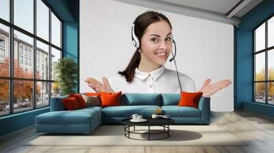 Beautiful smiling woman consultant of call center in headphones on gray background. female customer support operator with headset Wall mural