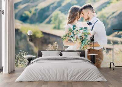 bride and groom hugging at the wedding in nature. Wall mural