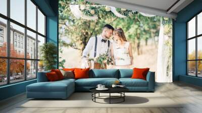 bride and groom hugging at the wedding in nature. Wall mural