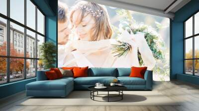 bride and groom hugging at the wedding in nature. Wall mural