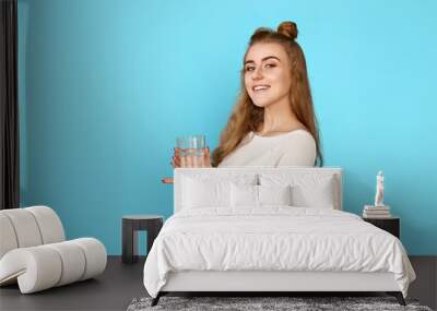 curly brunette woman with drinking glass of water Wall mural