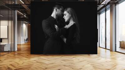 elegant couple in the tender passion. man embracing beautiful woman in black dress. black and white Wall mural