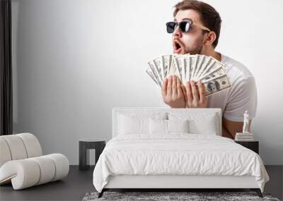 handsome smiling man with beard in shirt holding a lot of hundre Wall mural