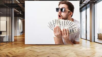 handsome smiling man with beard in shirt holding a lot of hundre Wall mural