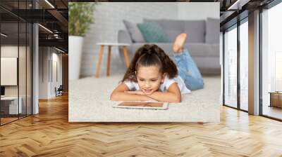 little child girl using digital tablet Wall mural