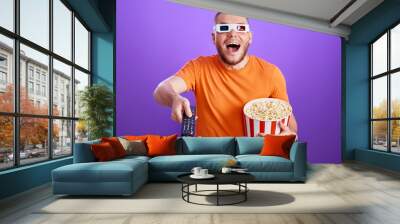 man in 3d glasses using console watching movie Wall mural