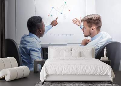 man standing near whiteboard and pointing on the chart Wall mural