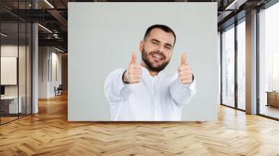 portrait of happy bearded man showing thumbs up on gray background. Wall mural