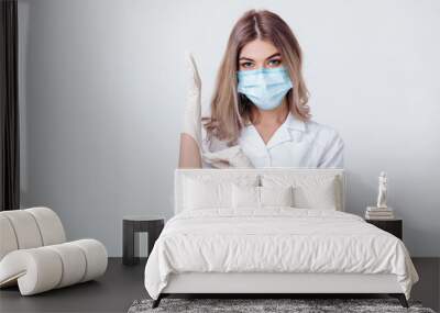 Portrait of woman doctor with face mask wearing white medical gloves Wall mural