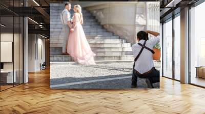 wedding photographer takes pictures of bride and groom Wall mural