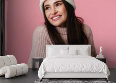 woman in hat, sweater hugging herself and smiling feeling happ Wall mural