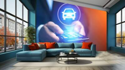 Businessman hand holding mobile phone with car icon Wall mural