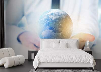 Businessman holding a 3d rendering particles earth globe Wall mural