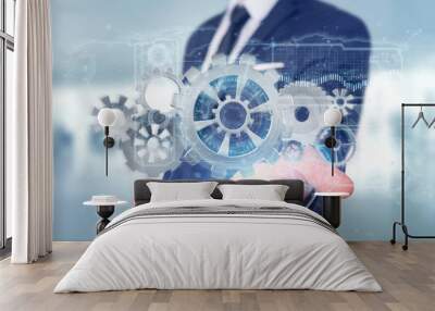 Man holding a technology gear wheel interface3d rendering Wall mural