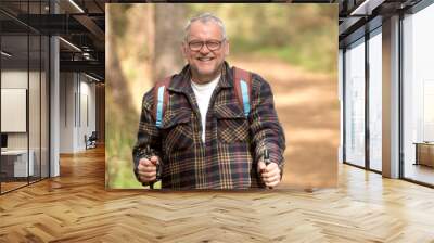 Portrait of a healthy senior attractive man hiking along the cost Wall mural