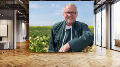 Portrait of a senior attractive farmer working in a field - Nature concept Wall mural