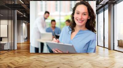 Portrait of a young attractive nurse at the hospital Wall mural