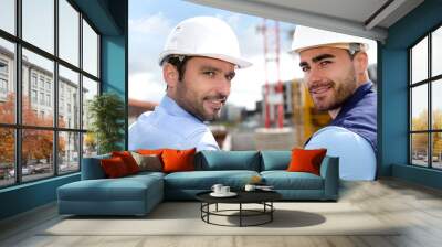 portrait of an attractive worker and an architect on a construct Wall mural