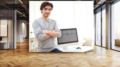 portrait of young man in front of computer Wall mural