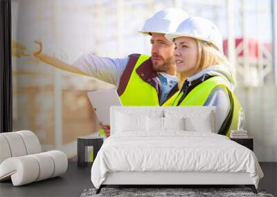 Two workers working outside on a construction site Wall mural