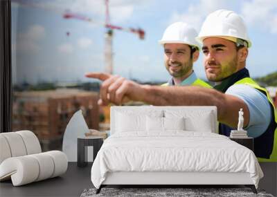 worker and architect watching some details on a construction Wall mural