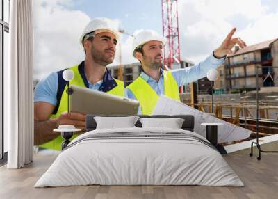 worker and architect watching some details on a construction Wall mural