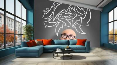 Young attractive perplexed geek man with brainstormaing arrow ov Wall mural