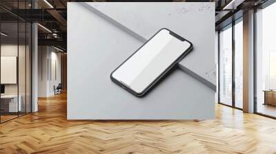 a cell phone is laying on a table with a white background Wall mural