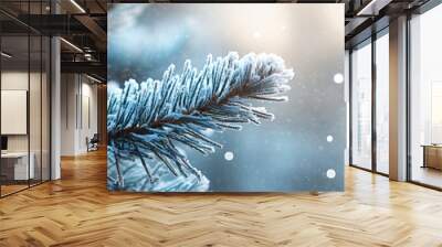 A snow covered pine tree branch with snowflakes falling on it. Concept of tranquility and peacefulness Wall mural