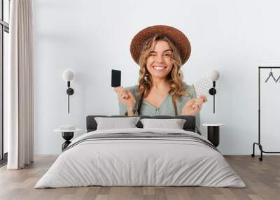 Happy young woman traveler wearing summer straw hat Wall mural