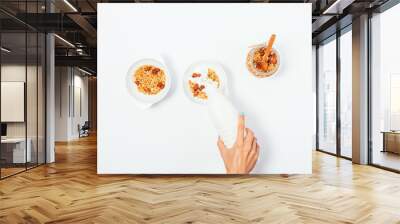 Woman doing healthy nut granola breakfast for two Wall mural