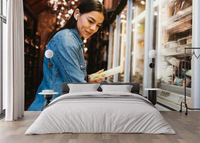 Young woman shopping food at grocery store Wall mural