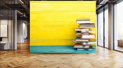 Composition with vintage old hardback books, diary, fanned pages on wooden deck table and abstract background. Books stacking. Back to school. Copy Space. Education background. Wall mural