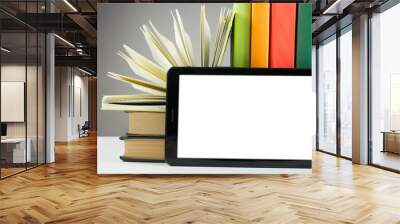 Stack of colorful books and electronic book reader. Electronic library concept. Back to school. Copy space Wall mural