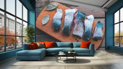 Raw fish cooking with spices on a wooden background. Wall mural