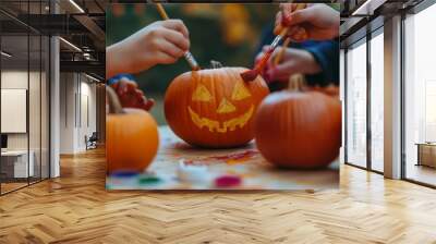 Children painting pumpkins together in a festive atmosphere during autumn celebrations, focused on creativity and fun Wall mural