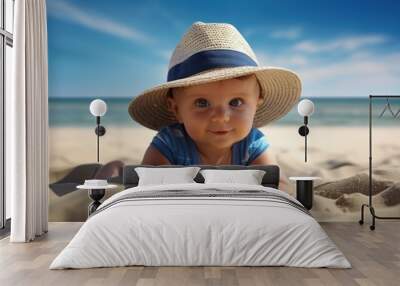 Against the background of a calm blue sea, a smiling child in a hat looks at the camera on the soft sand of the beach, blue sky with white clouds. Wall mural