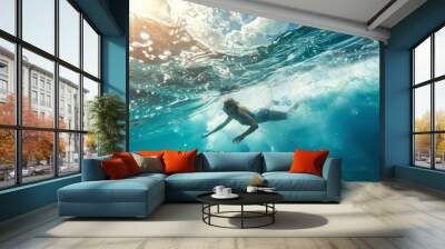 A woman is swimming in the ocean, enjoying the cool water and the refreshing waves on a sunny day. Wall mural