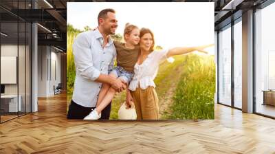 Adorable family spending time together looking at camera Wall mural