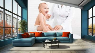 Adorable little baby child with female pediatrician Wall mural