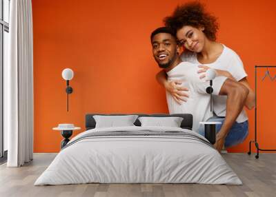 African-american couple having fun on orange background Wall mural