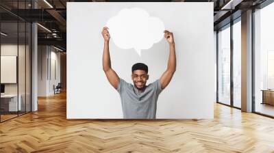 African-american man holding blank speech bubble on white Wall mural