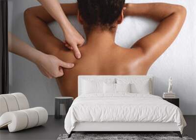 African american naked woman getting relaxing back massage on white Wall mural