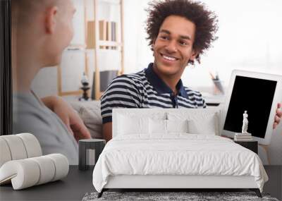 African-american teen boy showing tablet with blank screen Wall mural